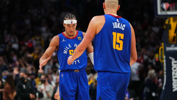 Oct 22, 2021; Denver, Colorado, USA; Denver Nuggets forward Aaron Gordon (50) and center Nikola Jokic (15) celebrate defeating the San Antonio Spurs at Ball Arena. Mandatory Credit: Ron Chenoy-USA TODAY Sports